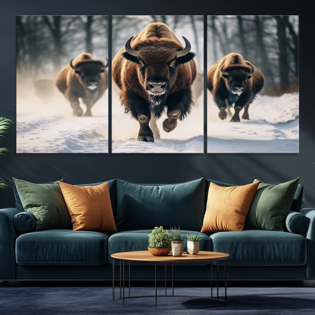 Wall art titled Cow Bighorn shows three bison running through snow in a forest.