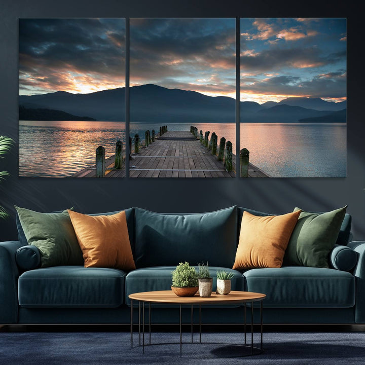 The Mountain Lake Wood Pier Canvas Wall Art depicts a serene lake and mountains, enhancing the beauty of any space.