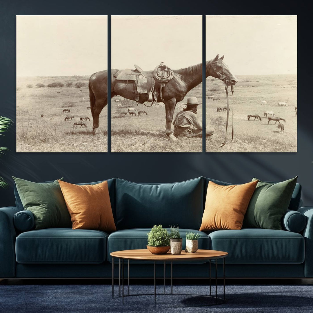 Cowboy Wall Art - Vintage Western Horse Canvas Print features a cowboy kneeling by his horse in a field.