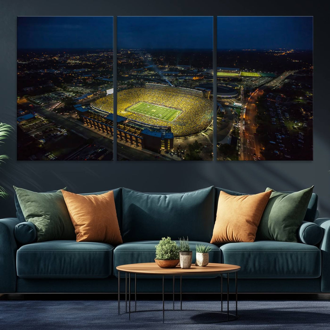 Aerial view of Michigan Stadium at night, surrounded by city lights, depicted on a Michigan Wolverines wall art canvas print.