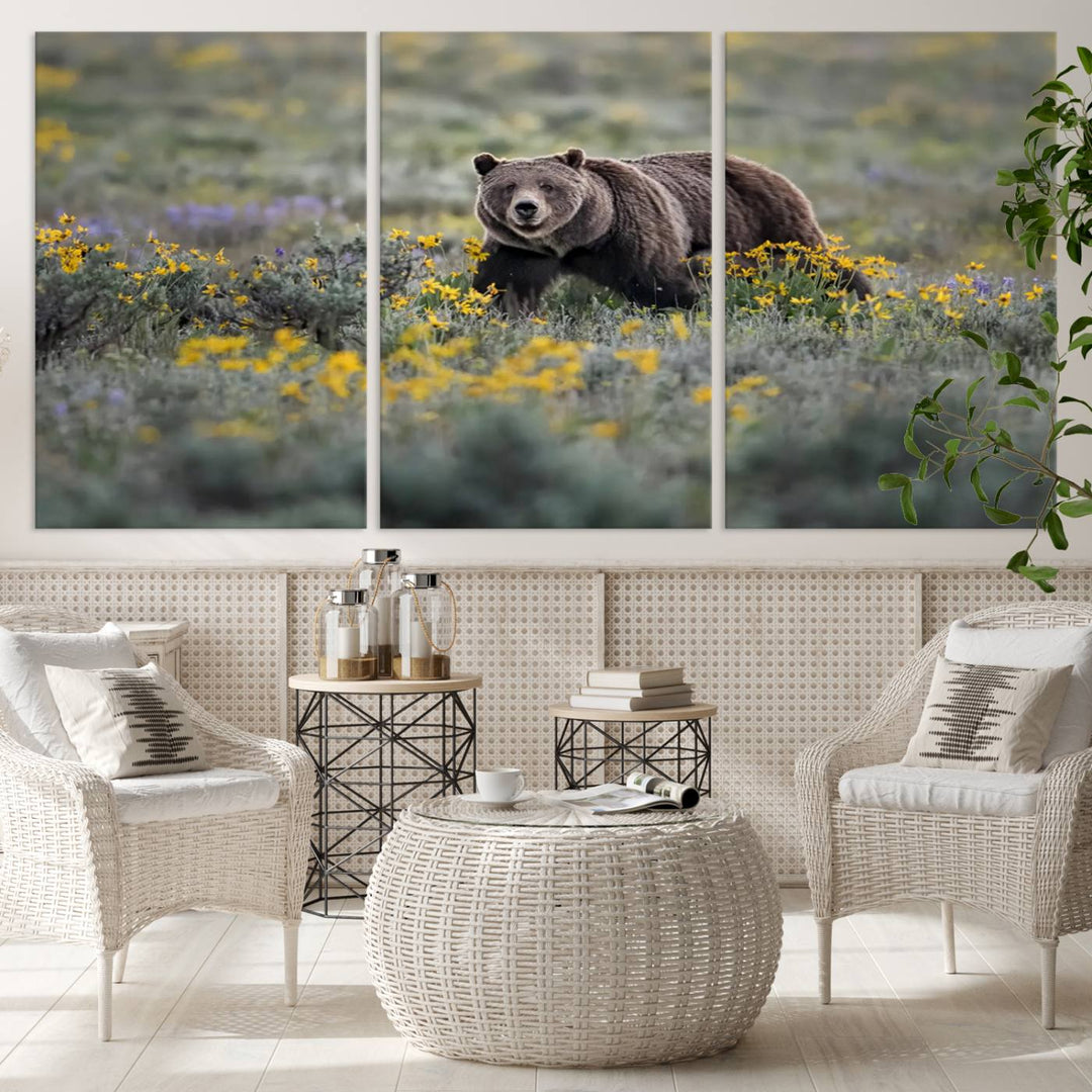 The "Grizzly 399 in Wild Flowers Wall Art Canvas Print" features a grizzly bear strolling through a field of yellow and purple flowers, beautifully showcased as a triptych. This handcrafted piece, proudly made in the USA, adds charm and sophistication to your space.