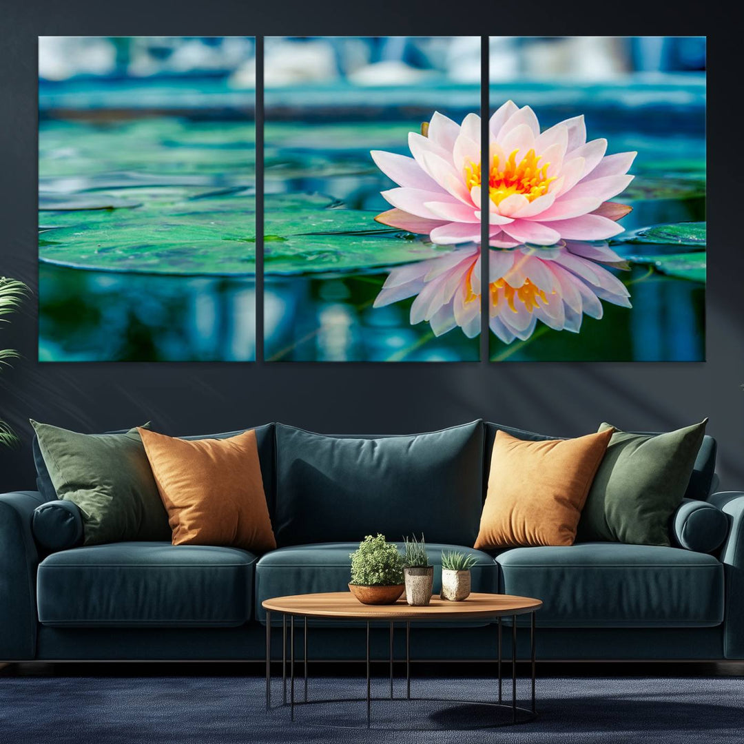 The Lotus Flower Canvas Print showcases a pink water lily with a yellow center gracefully floating on a calm pond.