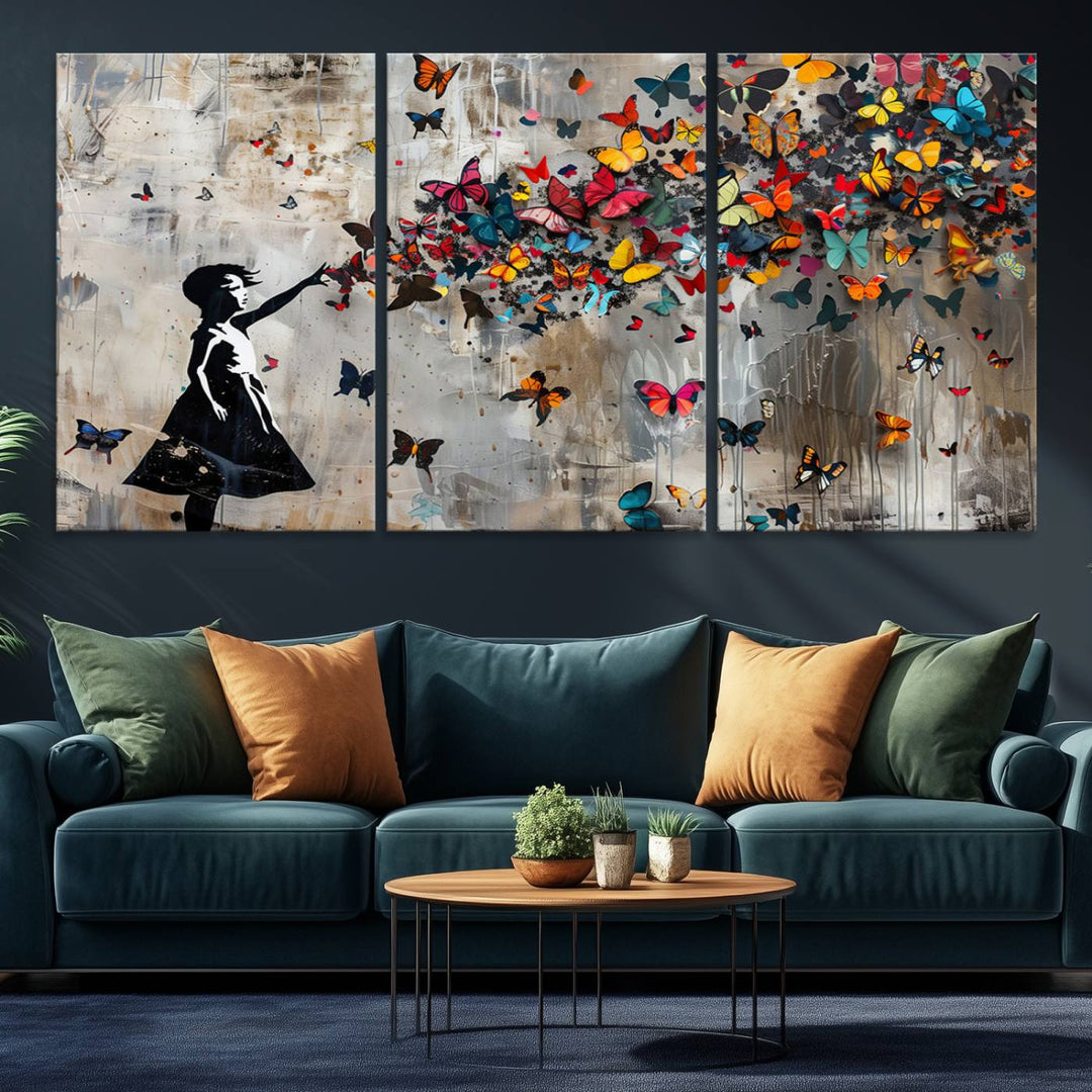 The Banksy Butterfly Girl 3-Piece Modern Graffiti Canvas Wall Art features a silhouette of a girl reaching for butterflies.