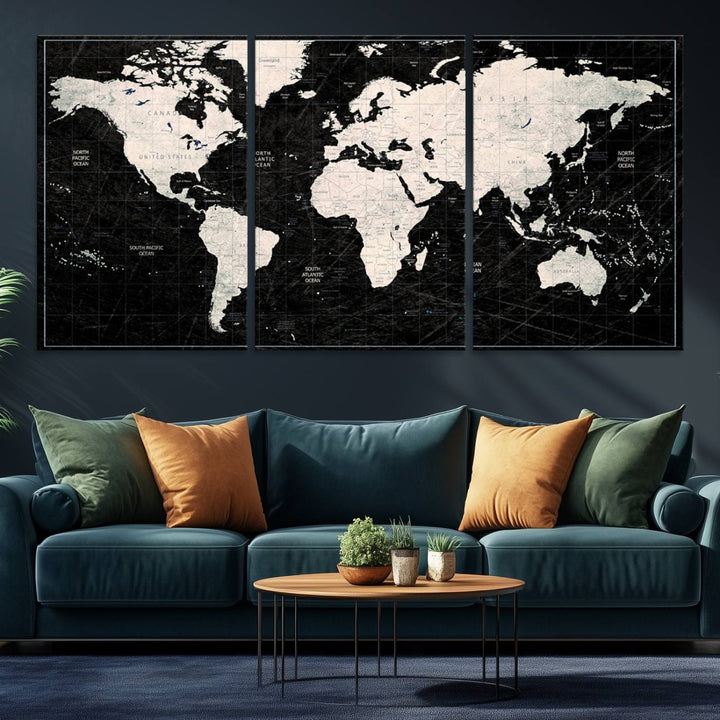 A bold global style framed black and white world map canvas print, presented in three panels, perfect for modern home or office decor.