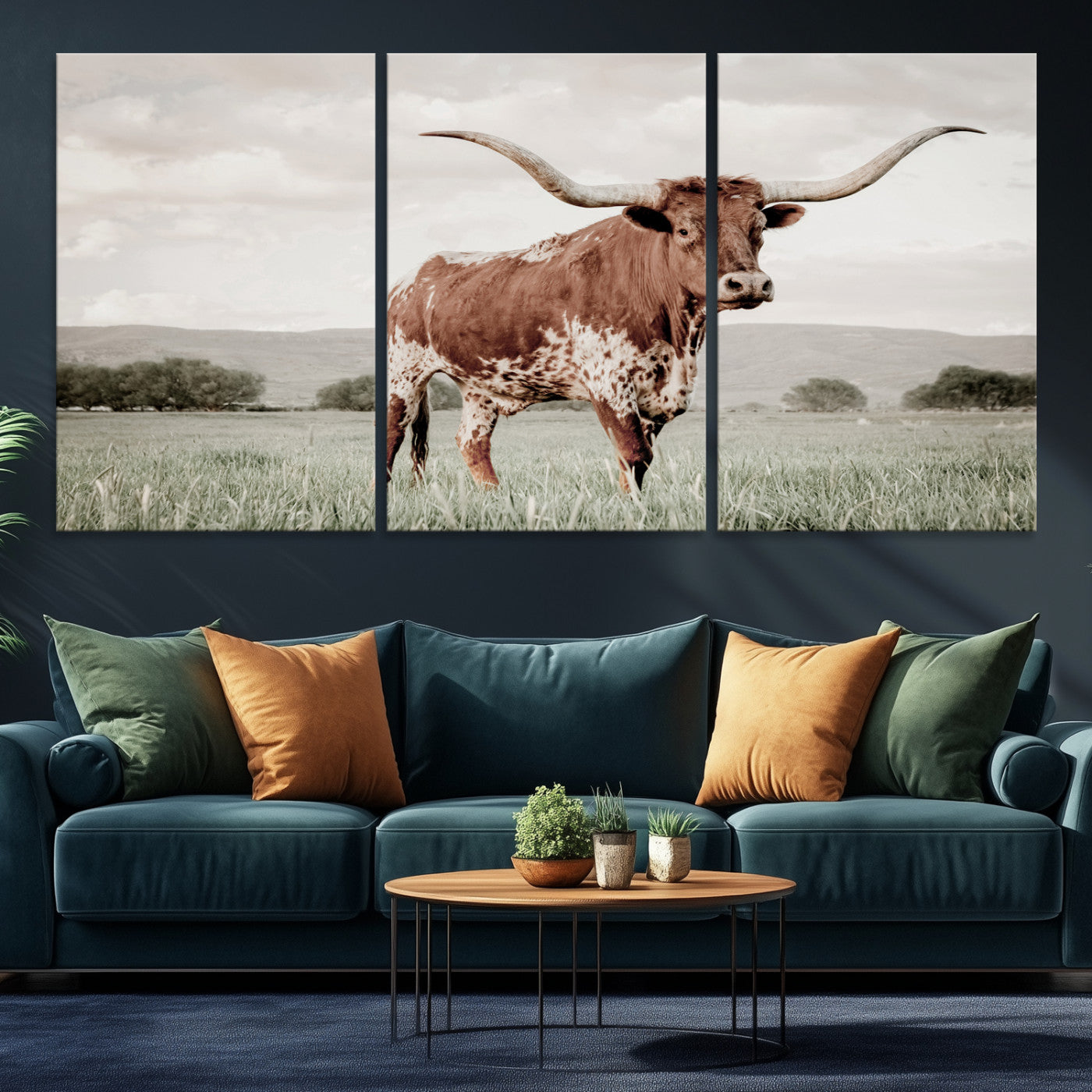 Canvas of a Texas longhorn standing in a grassy field with mountains in the background, ideal for rustic or country-style western wall decor.
