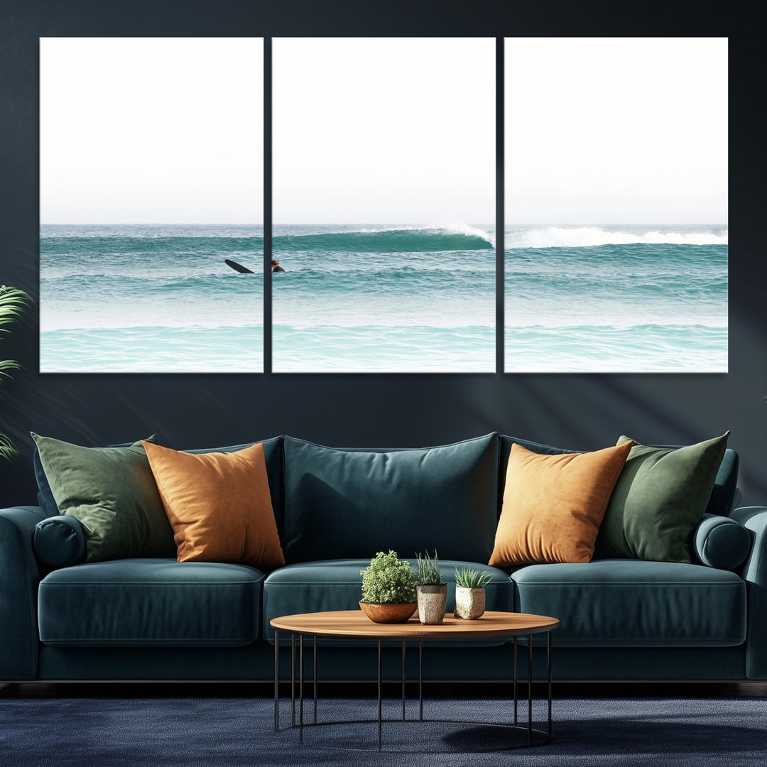 Minimalist photo of a lone surfer on calm aqua waves under bright sky, perfect for Scandinavian coastal or serene ocean-inspired home decor.