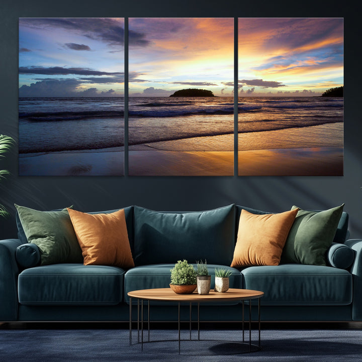 A tropical beach at sunset with waves gently washing ashore, reflecting golden and purple hues in the sky, creating a tranquil coastal scene.