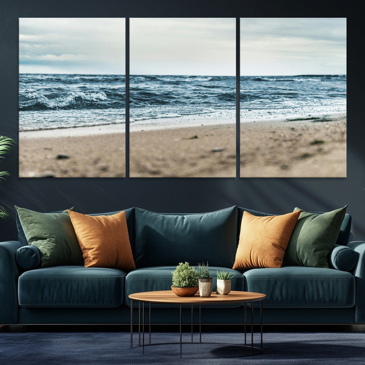 A moody ocean scene with gentle waves washing onto a sandy beach under a cloudy sky, creating a peaceful and coastal atmosphere.