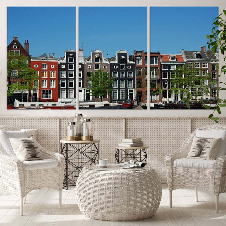 The Amsterdam City Wall Art Canvas Print showcases colorful traditional canal houses and boats set against a clear blue sky.