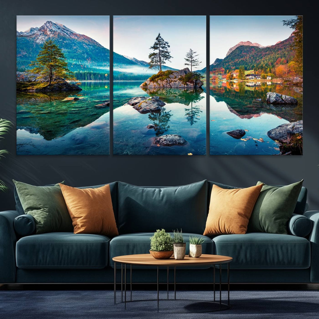 The 3-panel wall art showcases a serene mountain lake with rocky islands and trees, creating an ideal focal point for dining rooms or offices.