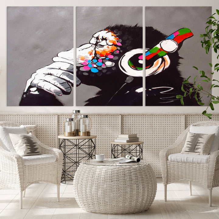 A vibrant triptych, the "DJ Monkey Listening to Music" wall art print, features a Banksy-inspired large canvas adorned with colorful modern pop art. This striking piece elegantly enhances the room with its dynamic and lively depiction.