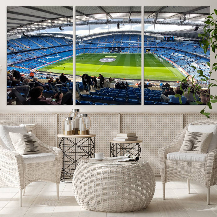 A captivating Manchester City Etihad Stadium Wall Art Canvas Print graces the living room, showcasing a football stadium with an empty field in a gallery-quality finish.