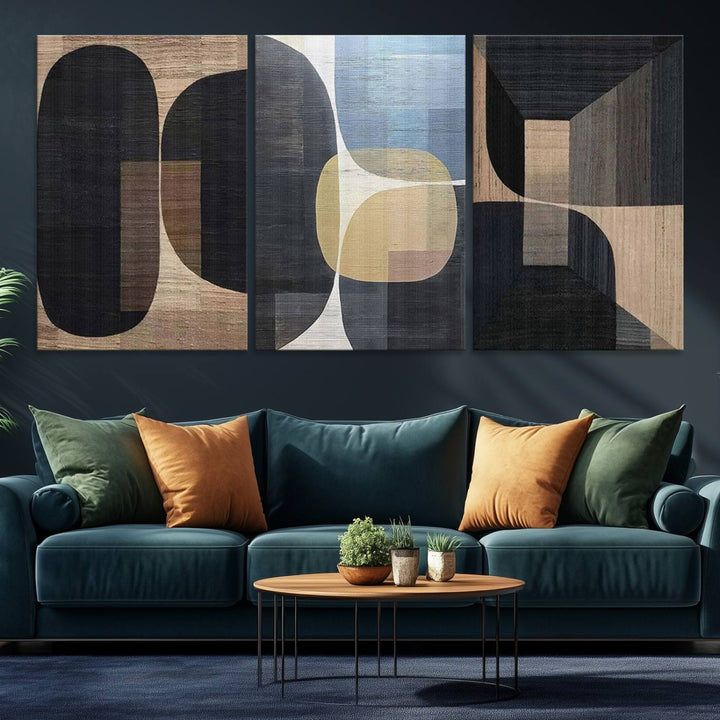 Abstract geometric wall art featuring black, gray, beige, and blue tones framed in a wooden border.