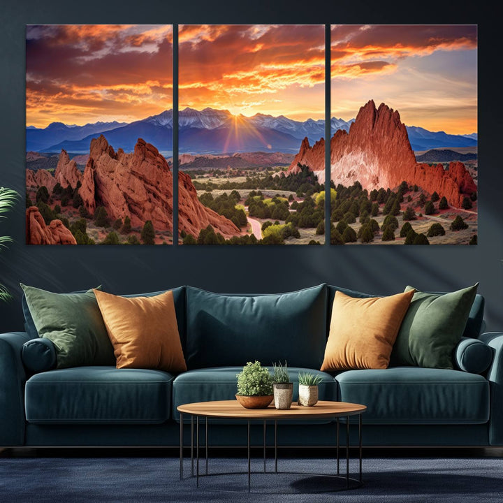 A vibrant sunset over the Rocky Mountains with red rocks.
