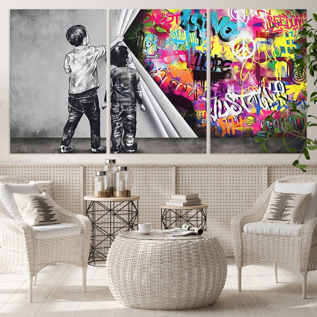 The Banksy Print - Street Art Canvas features a vibrant and bold image of two children lifting a curtain to reveal colorful graffiti. It's ready to hang, adding an urban modern decor vibe.