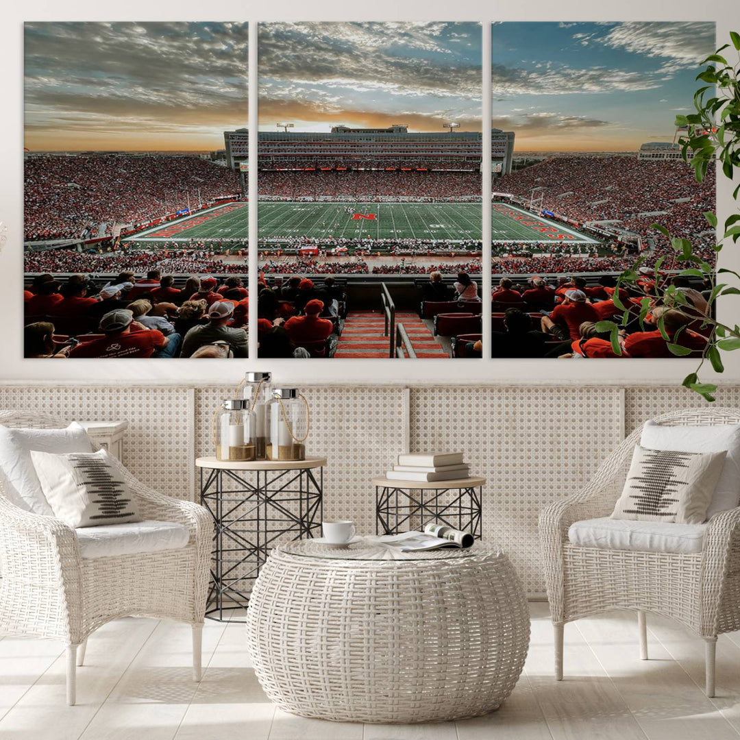 The living room features a stunning triptych of Lincoln Memorial Stadium wall art canvas print, celebrating the University of Nebraska Cornhuskers football team. This piece serves as captivating wall art, showcasing a gallery-quality finish.