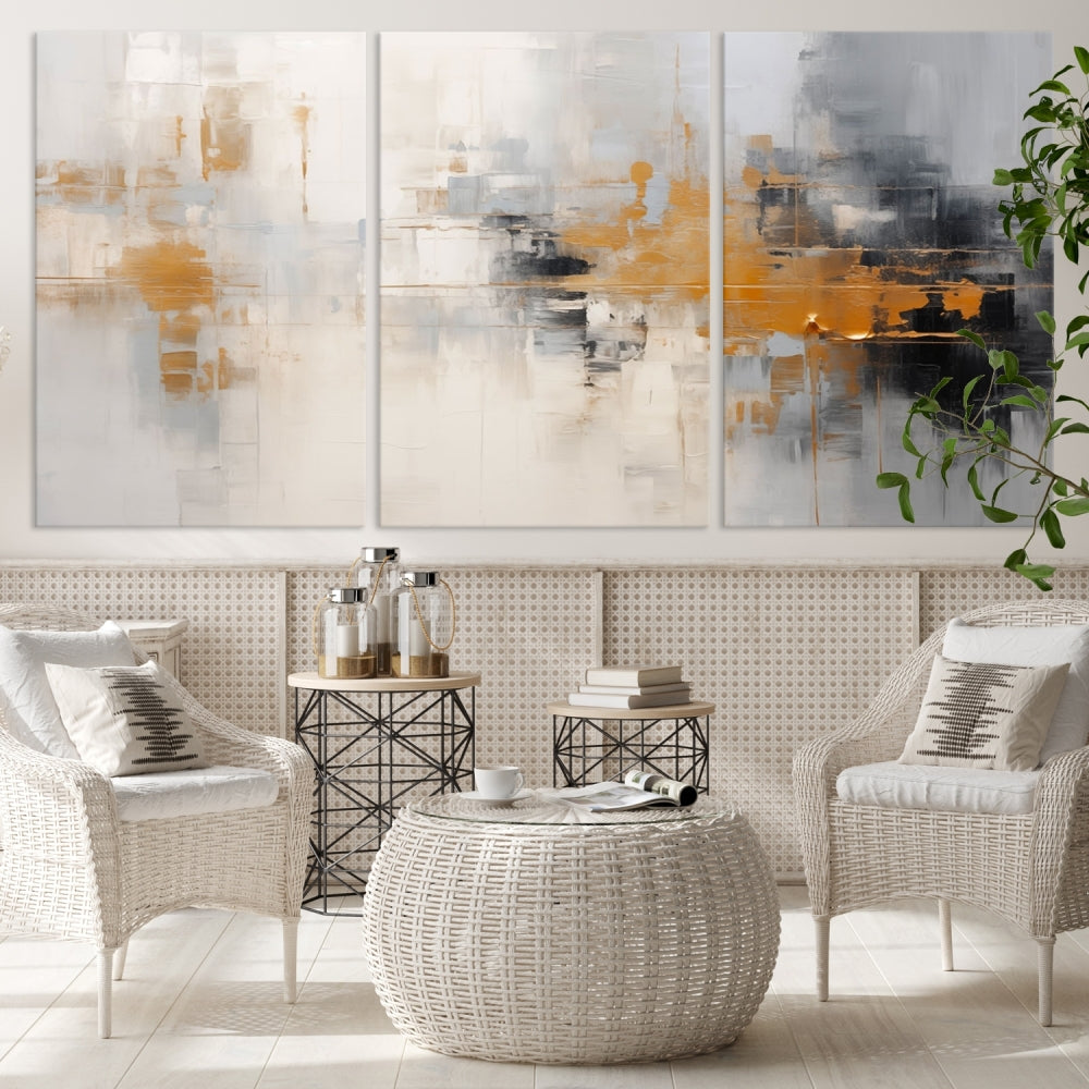 The Orange Pastel Abstract Wall Art Canvas Print, featuring a triptych of orange, white, and black hues, is elegantly displayed on museum-quality canvas.