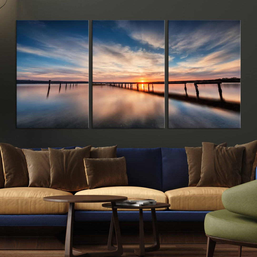 The Sunset Pier Canvas features a serene coastal landscape with vibrant hues under cloudy skies, ideal for modern decor.