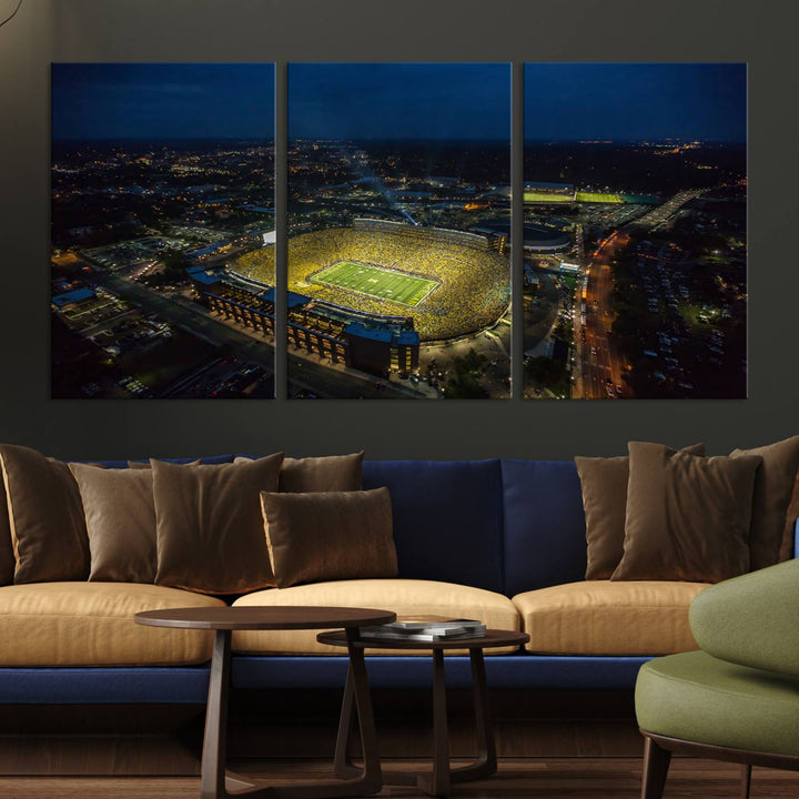 Aerial view of Michigan Stadium at night, surrounded by city lights, depicted on a Michigan Wolverines wall art canvas print.