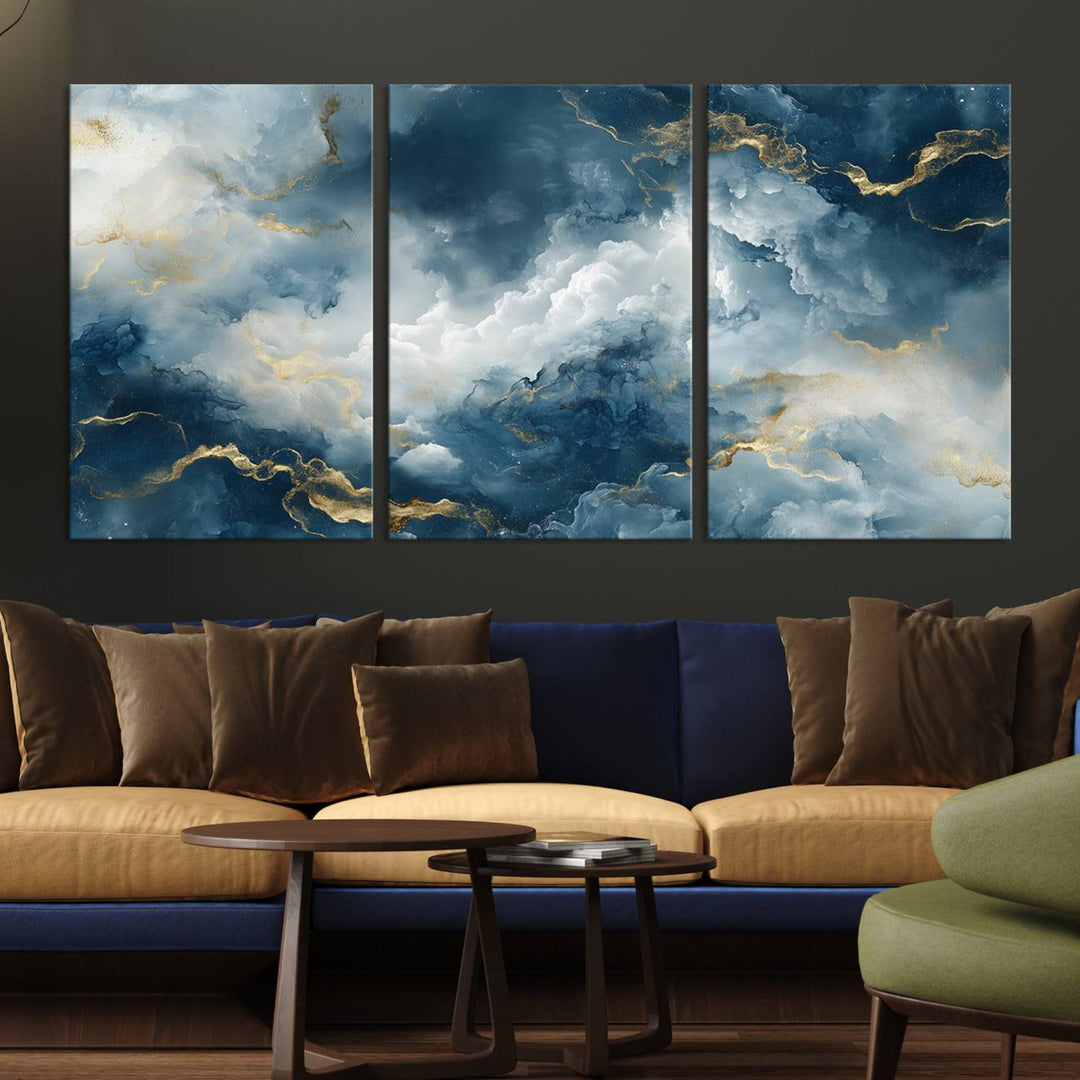 Modern living room featuring the Large Abstract Print - Luxe Blue and Gold Abstract Canvas Wall Art that showcases a bold cloudscape, perfect for modern home decor.