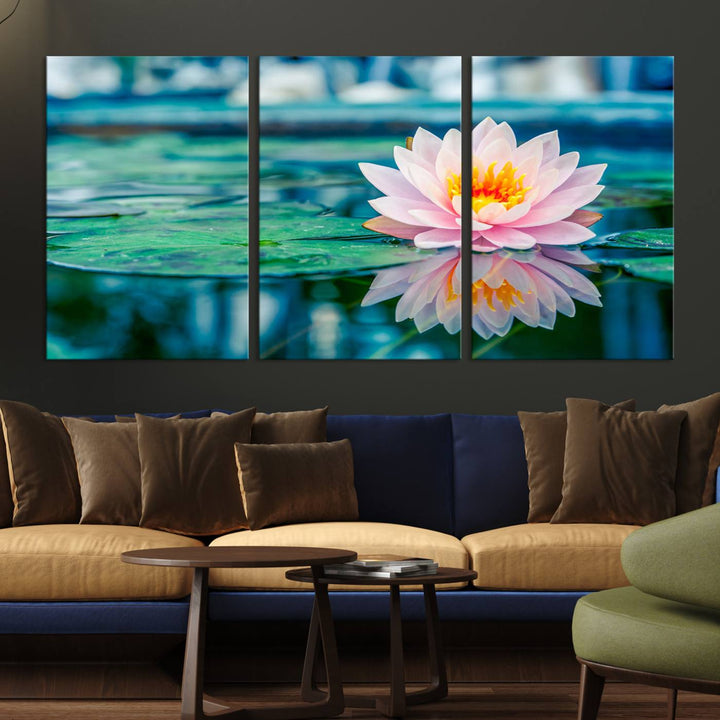 The Lotus Flower Canvas Print showcases a pink water lily with a yellow center gracefully floating on a calm pond.