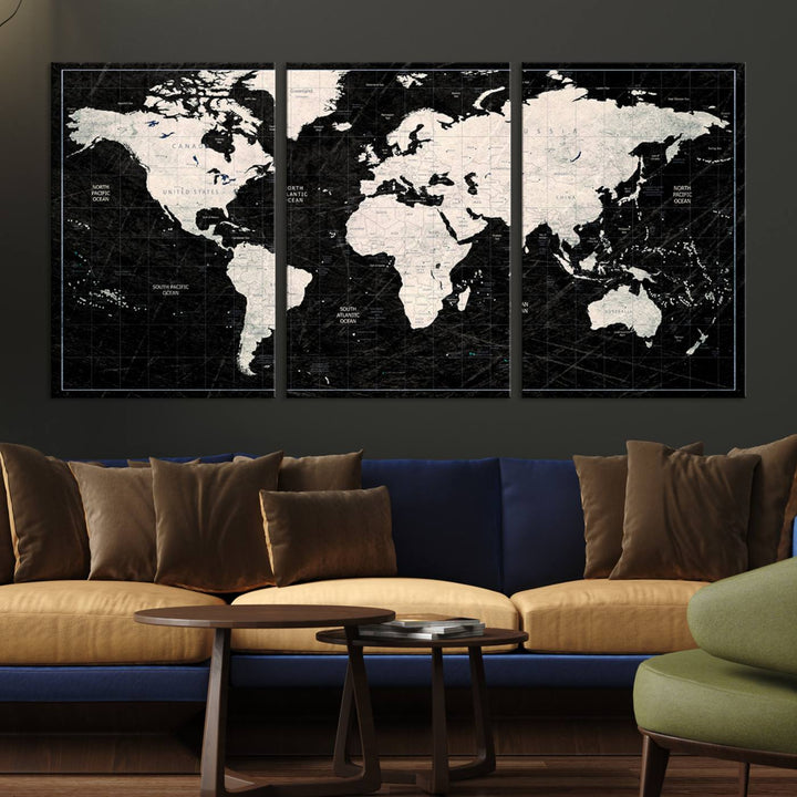 A bold global style framed black and white world map canvas print, presented in three panels, perfect for modern home or office decor.