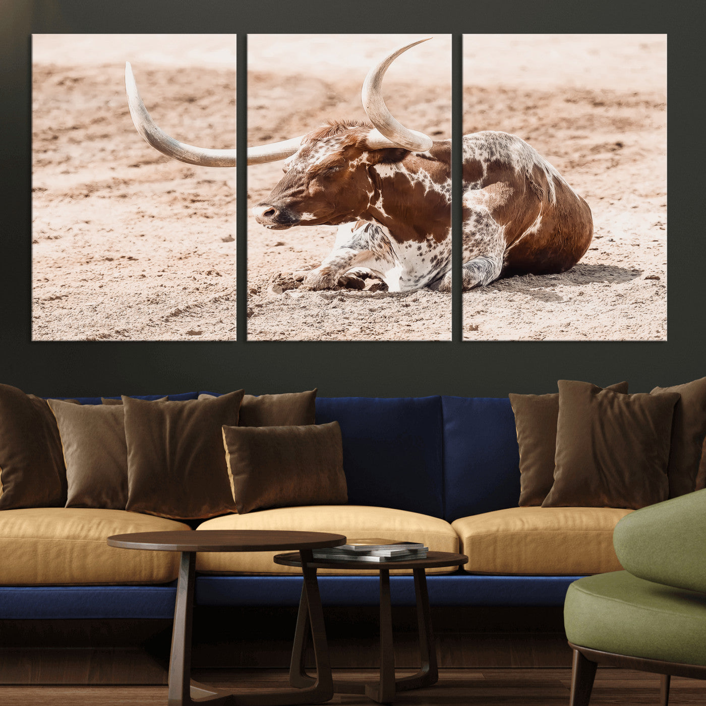 Texas Longhorn bull resting on dusty ground with warm tones, ideal for rustic western or farmhouse-themed wall decor.