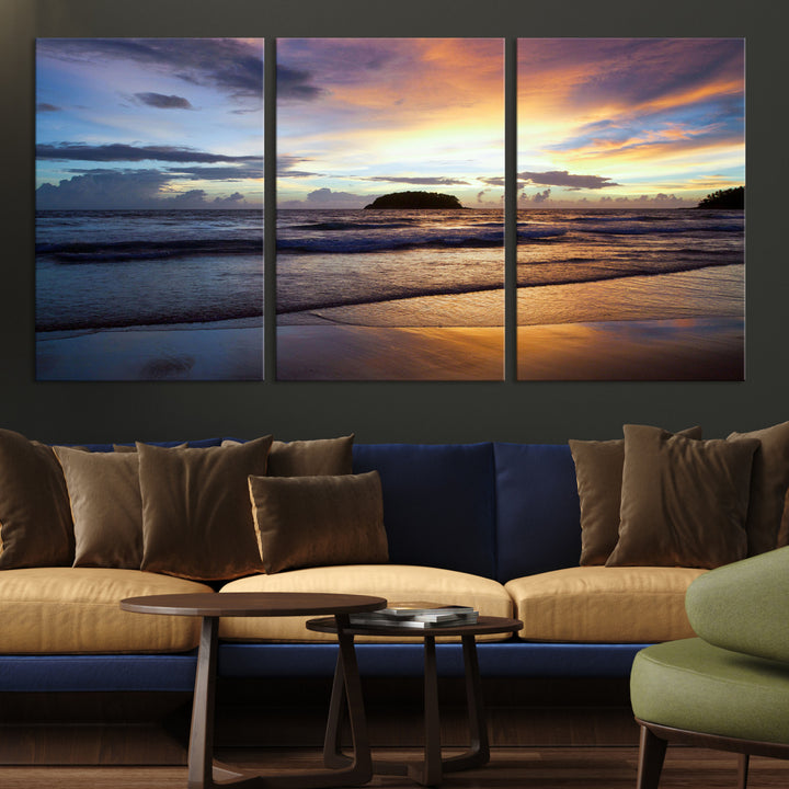 A tropical beach at sunset with waves gently washing ashore, reflecting golden and purple hues in the sky, creating a tranquil coastal scene.