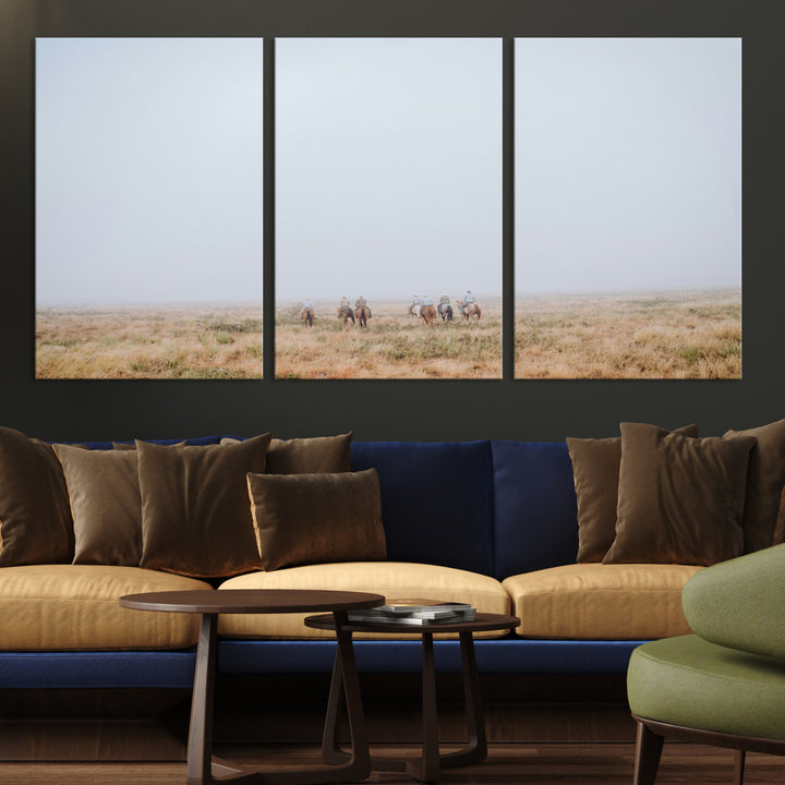 A group of horseback riders moving through a fog-shrouded field, evoking a calm Western scene with golden grasses and soft horizons.