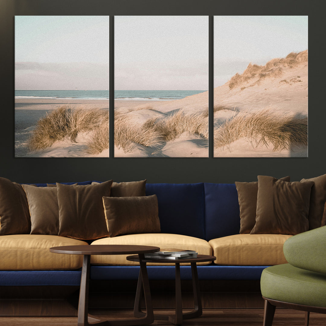 Soft pastel-toned beach scene with sand dunes, windswept grasses, and a calm ocean horizon, creating a serene coastal atmosphere.