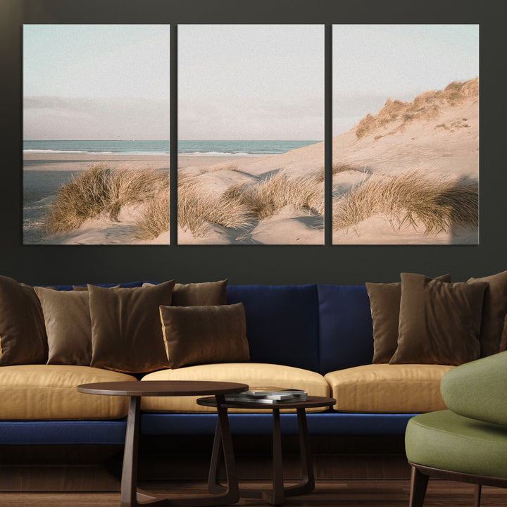 Soft pastel-toned beach scene with sand dunes, windswept grasses, and a calm ocean horizon, creating a serene coastal atmosphere.