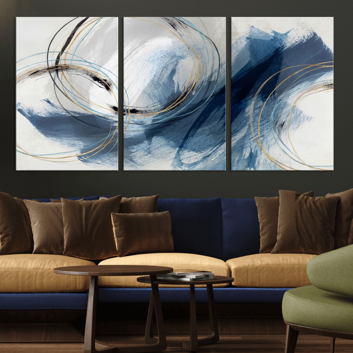 Abstract wall art featuring dynamic brush strokes in shades of blue and gray, overlaid with delicate circular line patterns in gold, black, and light blue on a white background.