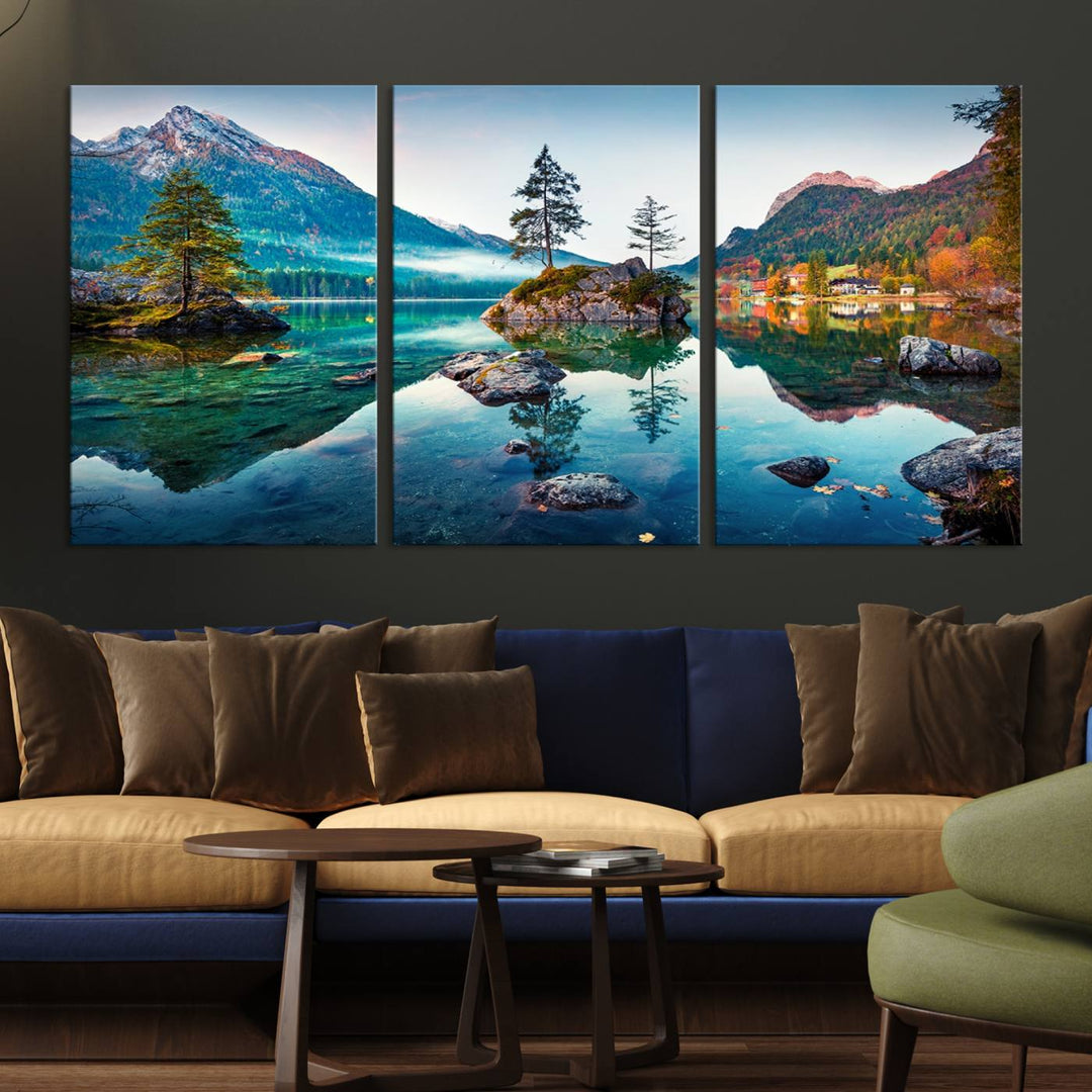 The 3-panel wall art showcases a serene mountain lake with rocky islands and trees, creating an ideal focal point for dining rooms or offices.