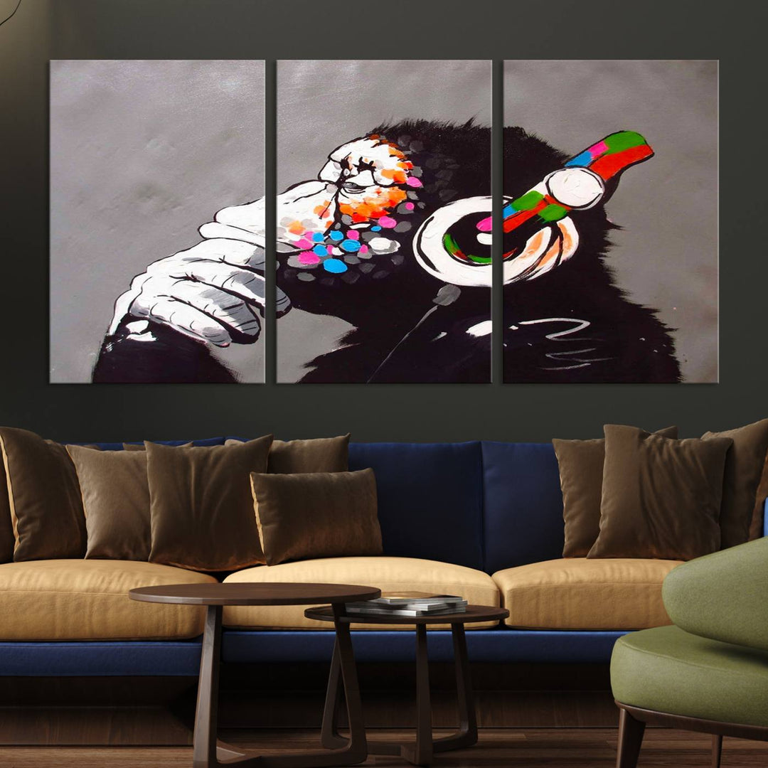 A vibrant triptych, the "DJ Monkey Listening to Music" wall art print, features a Banksy-inspired large canvas adorned with colorful modern pop art. This striking piece elegantly enhances the room with its dynamic and lively depiction.