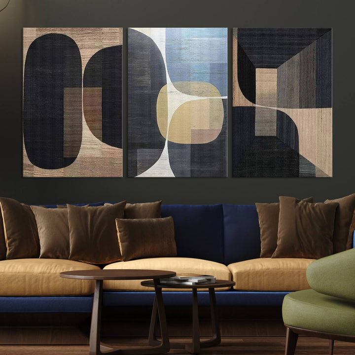 Abstract geometric wall art featuring black, gray, beige, and blue tones framed in a wooden border.