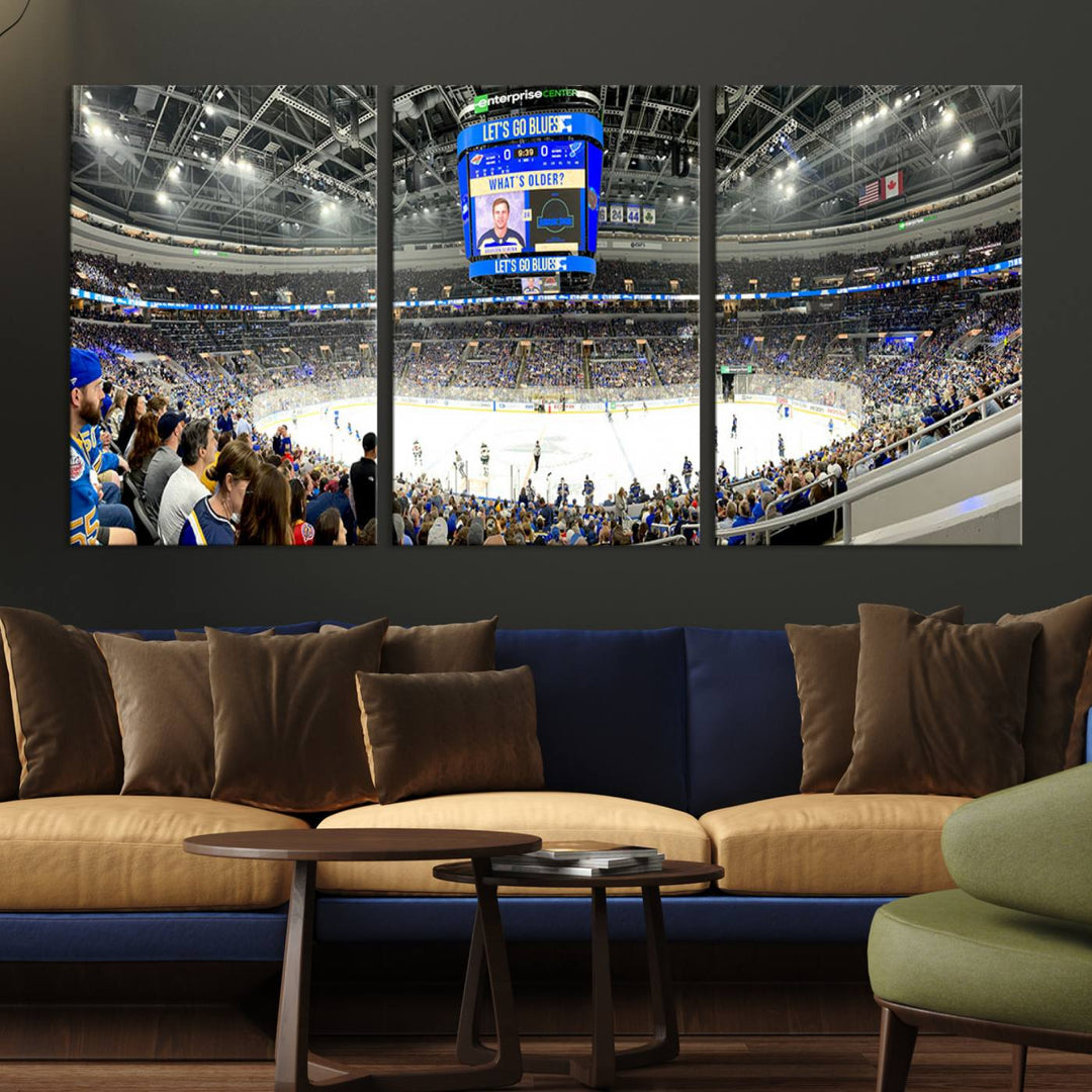 Wall art prints depicting the bustling scenes of the St. Louis Blues being cheered on by a full house at the Enterprise Center, beneath a large scoreboard.