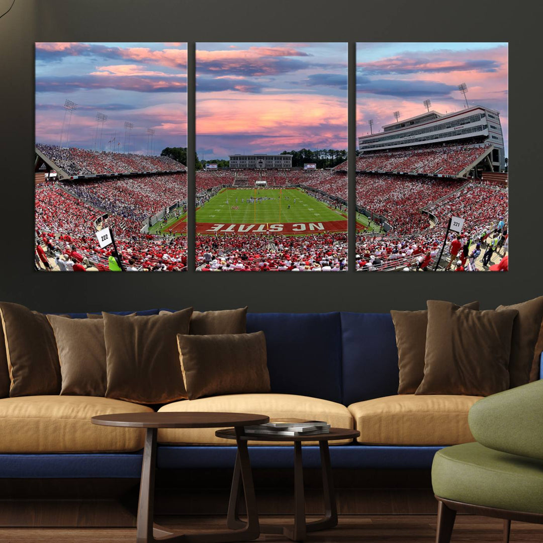 The wall art captures an NC State Wolfpack game under a vibrant sunset on triple canvas.