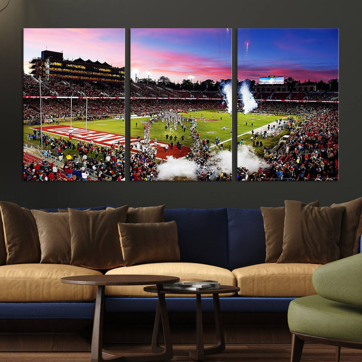 The wall art features a canvas print of the Stanford Cardinal football team, capturing players, fireworks, and smoke against the backdrop of a sunset at Stanford Stadium.