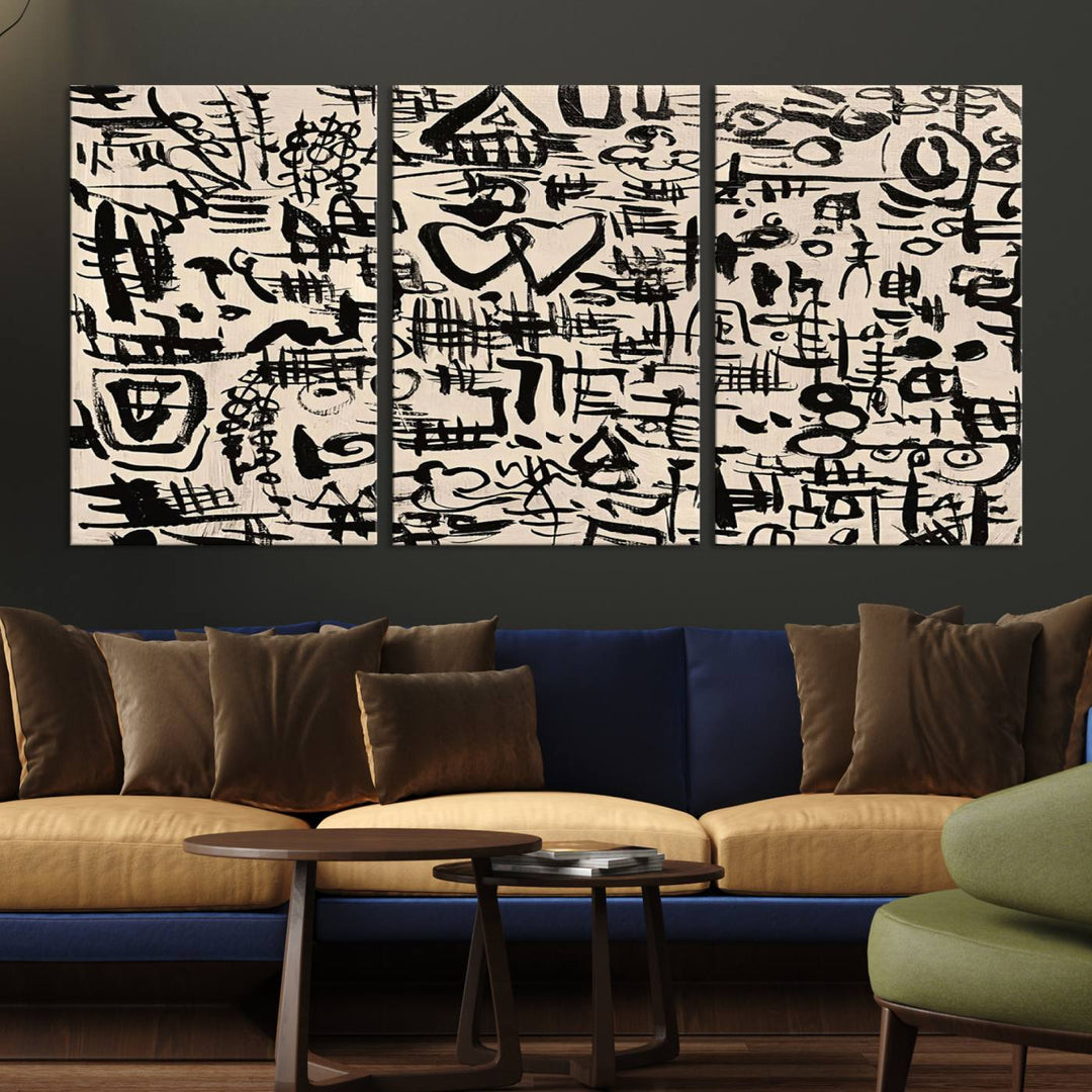 The Abstract Love and Chaos canvas is a museum-quality print featuring black symbols on a beige background, adorned with a heart and scribble design. It is framed to enhance its artistic appeal.