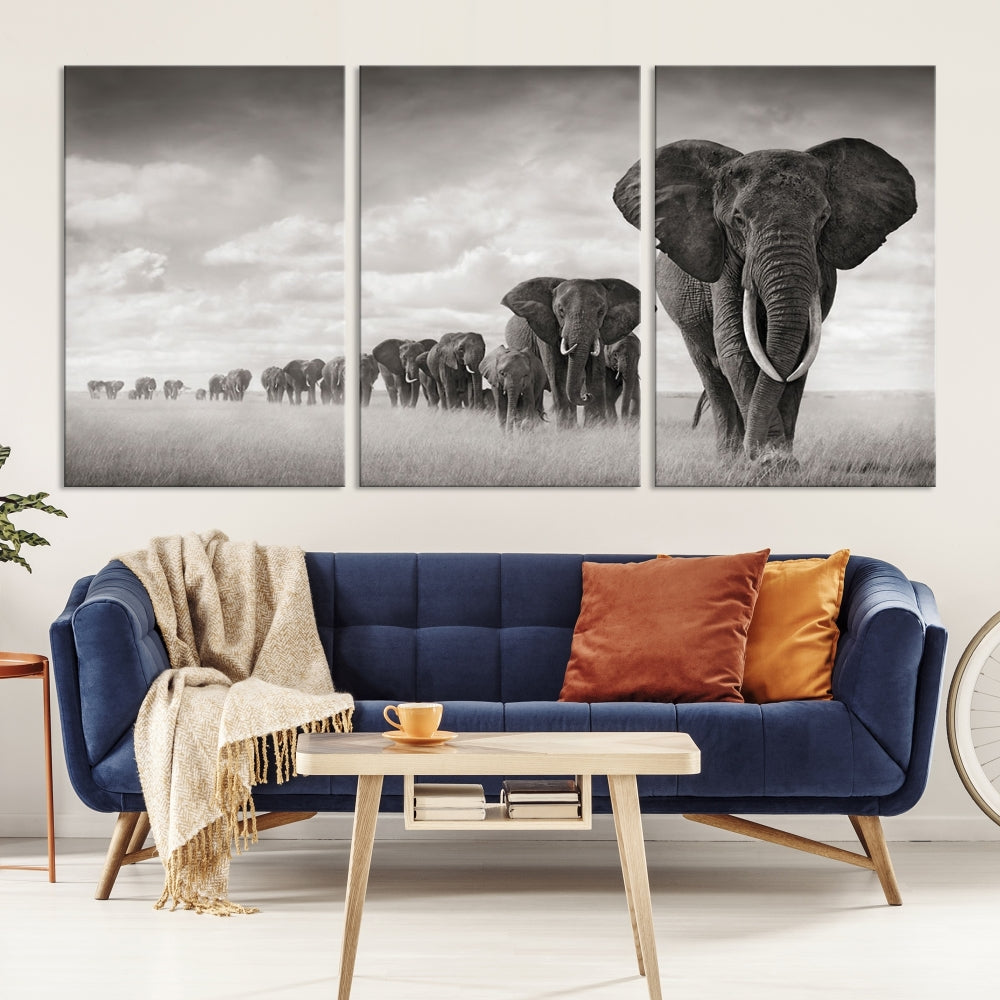 The "Herd of Elephants Wall Art Canvas Print" features an elegant black and white triptych of elephants walking in a line, beautifully displayed on museum-quality canvas with a UV-protective coating. This artwork arrives ready to hang and adds sophistication to any space.