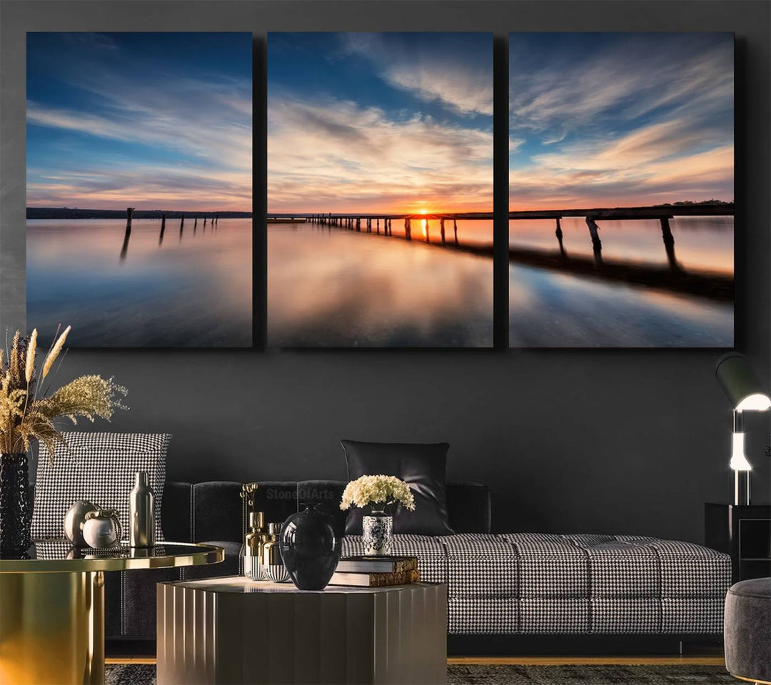 The Sunset Pier Canvas features a serene coastal landscape with vibrant hues under cloudy skies, ideal for modern decor.