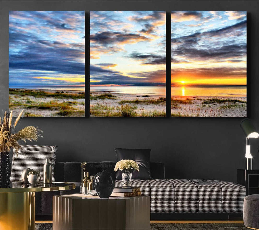 The Sunset On The Ocean canvas wall art features a beautiful beach sunset with grass and clouds.