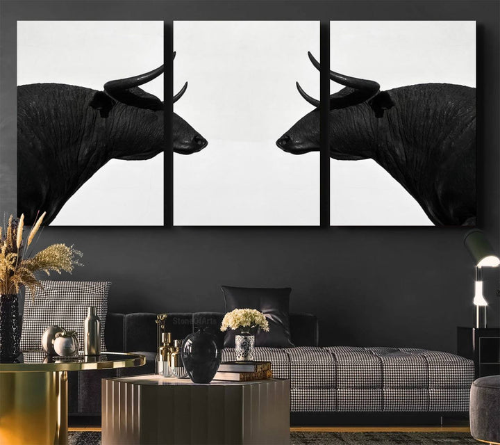 A framed canvas print featuring two black bull silhouettes, perfect for modern rustic decor.