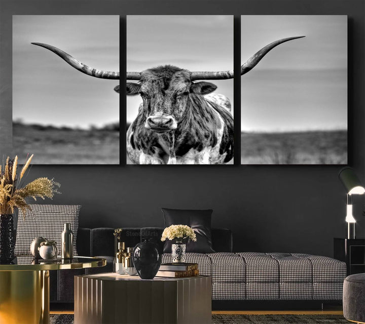 The Texas Longhorn Cow wall art, divided into three panels, is of gallery quality and displayed on a dark wall.