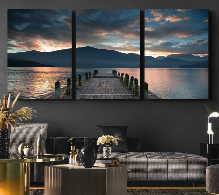 The Mountain Lake Wood Pier Canvas Wall Art depicts a serene lake and mountains, enhancing the beauty of any space.