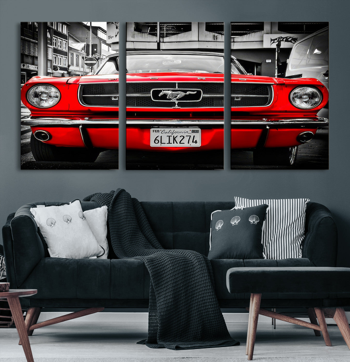 Front view of a bold red 1960s Ford Mustang parked in an urban environment, captured in dramatic contrast with a black-and-white city backdrop, emphasizing its timeless American muscle car identity.