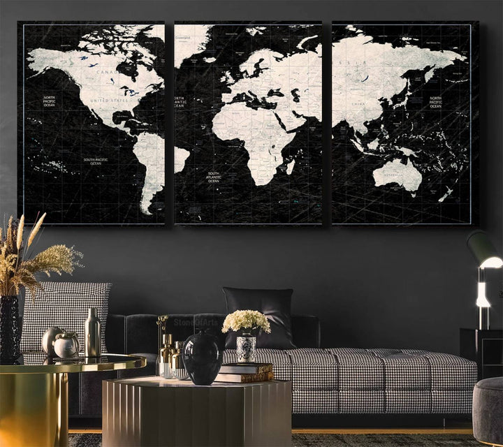A bold global style framed black and white world map canvas print, presented in three panels, perfect for modern home or office decor.
