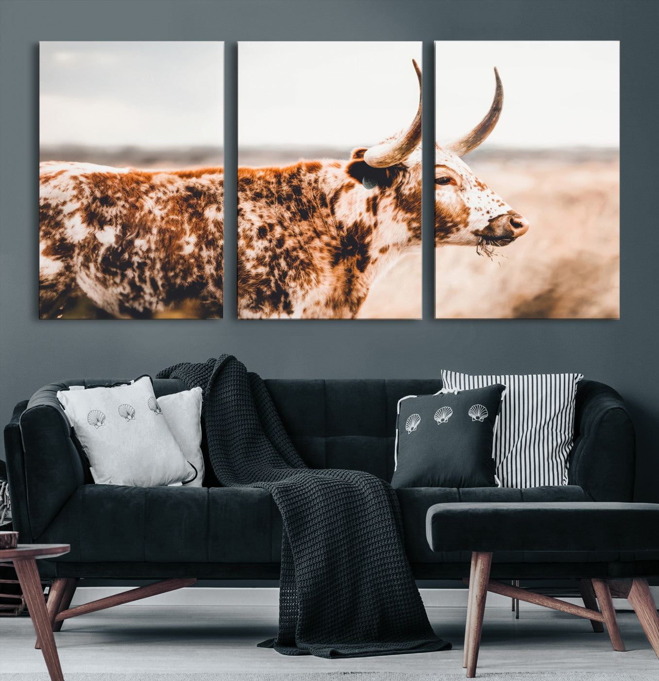 Speckled Texas longhorn with curved horns standing in a warm-toned prairie, perfect for rustic or country-style home decor.