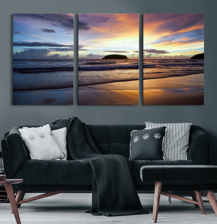 A tropical beach at sunset with waves gently washing ashore, reflecting golden and purple hues in the sky, creating a tranquil coastal scene.