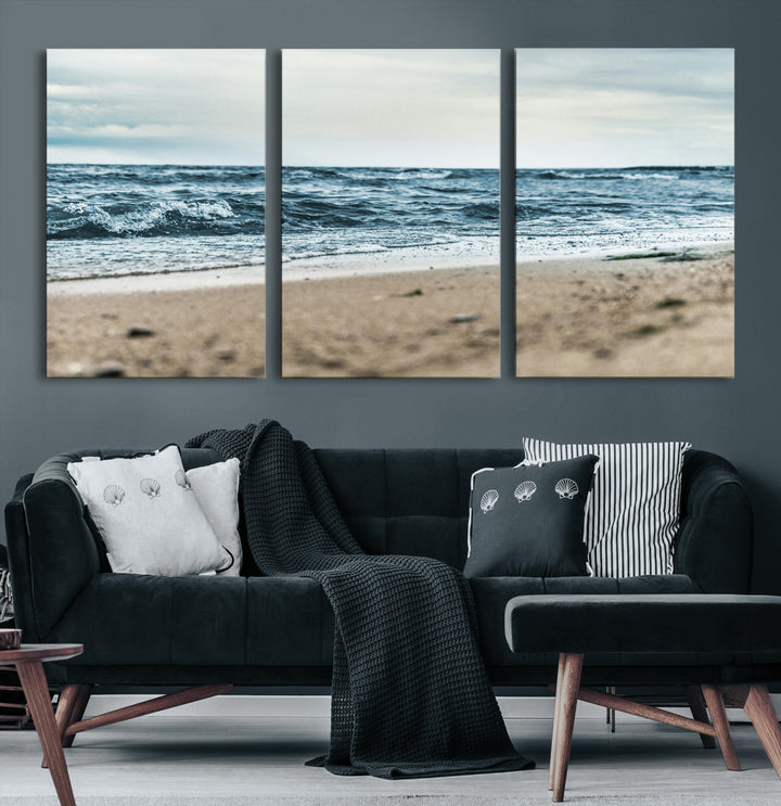 A moody ocean scene with gentle waves washing onto a sandy beach under a cloudy sky, creating a peaceful and coastal atmosphere.